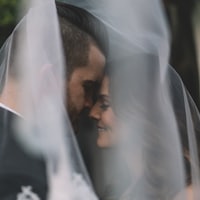 Couple under a veil at a wedding